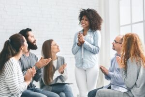 Group smiling during an Alcoholics Anonymous session