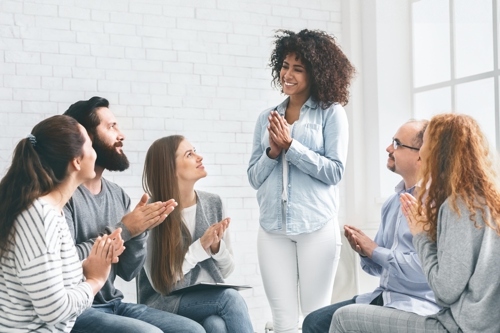 Group smiling during an Alcoholics Anonymous session