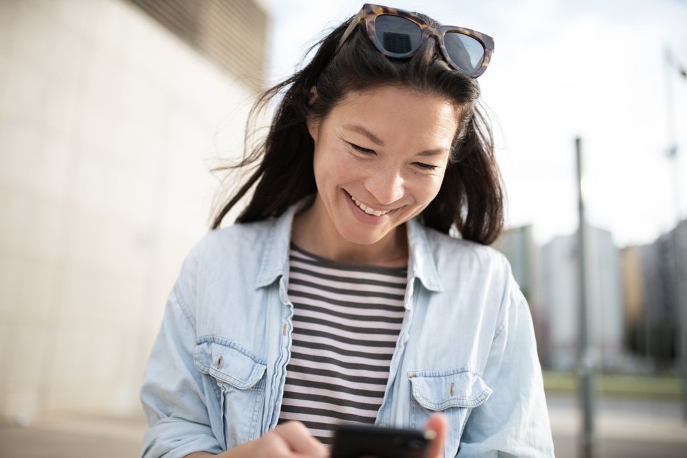 Female smiling after reading sober anniversary messages